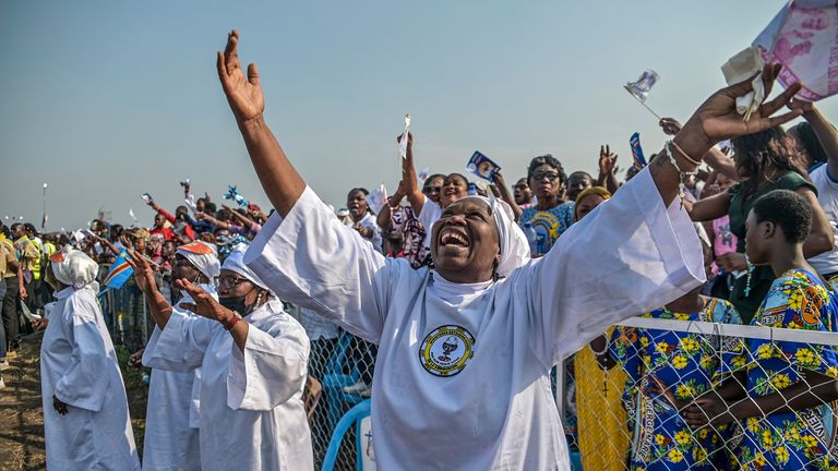 Worshipers greet Pope Francis as he arrives at Ndolo airport. Pic: AP