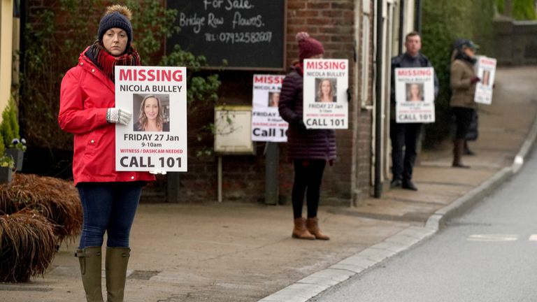 Friends of missing woman Nicola Bulley hold missing person appeal posters along the main road in the village in St Michael&#39;s on Wyre, Lancashire 