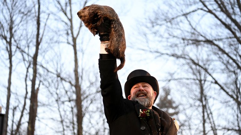 AJ Dereume holds up Phil the groundhog as he is to make his prediction on how long winter will last during the Groundhog Day Festivities, at Gobblers Knob in Punxsutawney, Pennsylvania