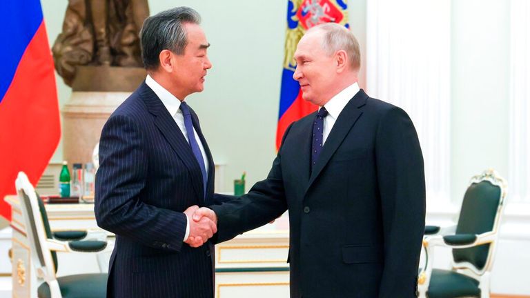 Vladimir Putin greets Chinese Communist Party&#39;s foreign policy chief Wang Yi in Moscow. Pic: AP
