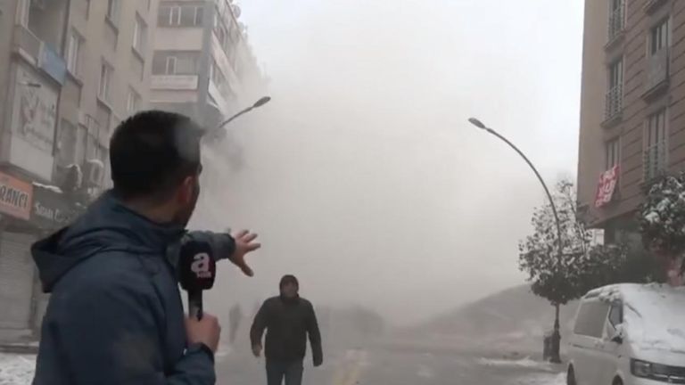 A reporter for A News was filming in the streets of Malatya, when an aftershock appears to demolish a building as people run away.
