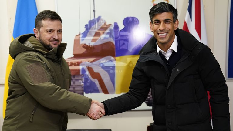 Prime Minister Rishi Sunak and Ukrainian President Volodymyr Zelensky shake hands after meeting Ukrainian troops being trained to command Challenger 2 tanks at a military facility in Lulworth, Dorset. Picture date: Wednesday February 8, 2023.