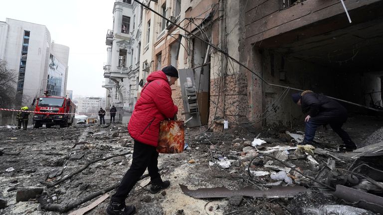 Owners of apartments enter a residential building which was hit by a Russian rocket at the city center of Kharkiv, Ukraine
Pic:AP