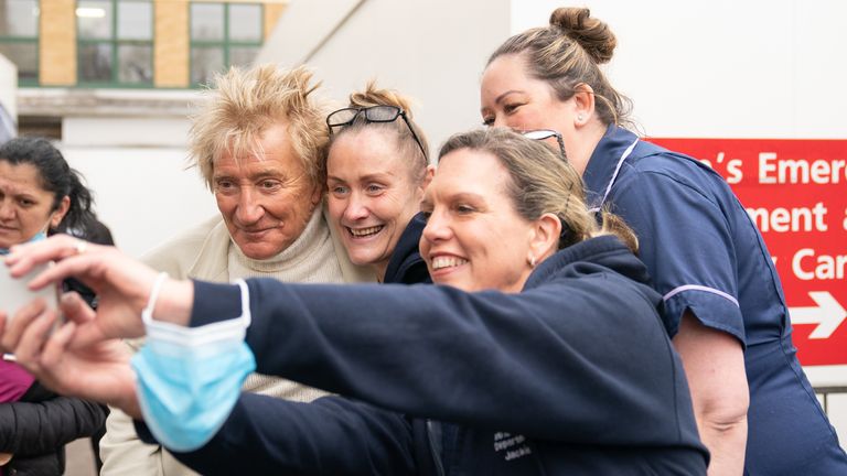 Sir Rod Stewart takes a selfie with members of staff at the Princess Alexandra Hospital in Harlow, Essex. The musician is meeting patients and medics at the hospital after he called a phone-in segment on live Sky News in January, and offered to pay for people to have hospital scans, amid the rising number of people on NHS waiting lists. Picture date: Friday February 24, 2023.
