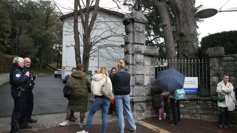 Police officers guard the entrance of a private Catholic school after a teacher has been stabbed to death by a high school student, Wednesday, Feb. 22, 2023 in Saint-Jean-de-Luz, southwestern France. The student has been arrested by police, the prosecutor of Bayonne said. Pic:AP