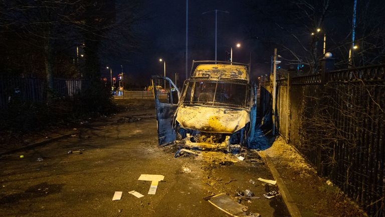 A burnt out police van