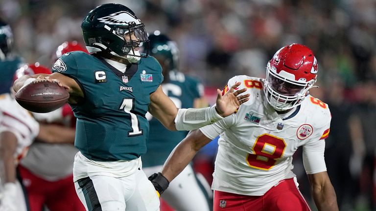 Philadelphia Eagles quarterback Jalen Hurts (1) passes under pressure by Kansas City Chiefs defensive end Carlos Dunlap (8) during the second half of the NFL Super Bowl 57 football game, Sunday, Feb. 12, 2023, in Glendale, Ariz. (AP Photo/Brynn Anderson)