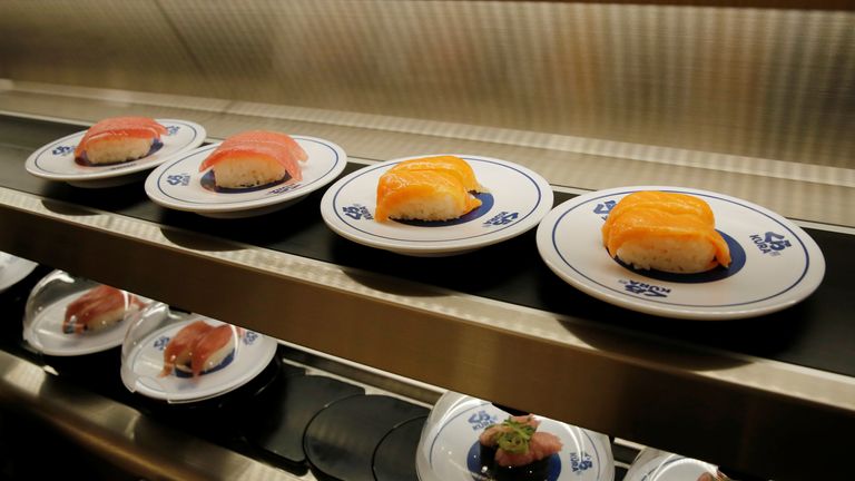 Sushi is seen on a conveyor belt at a Kura Sushi restaurant in Tokyo, Japan in 2021