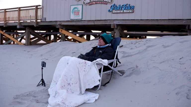 Peter Flynn of Myrtle Beach sits on the beach near Springmaid Pier, in Myrtle Beach, South Carolina, watching the Chinese balloon get shot down