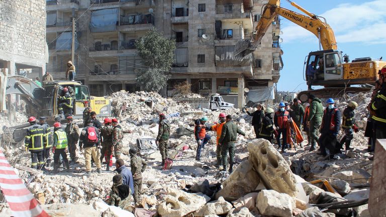 Members of the Algerian rescue team and Syrian army soldiers search for survivors in Aleppo, Syria 