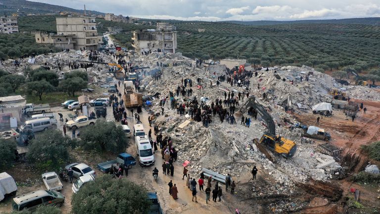 Civil defense workers and residents search through the rubble of collapsed buildings in the town of Harem near the Turkish border, Idlib province, Syria 
Pic:AP