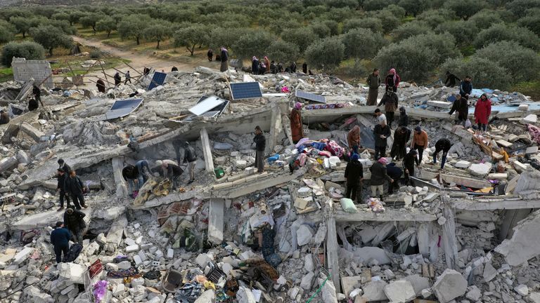 Civil defense workers and residents search through the rubble of collapsed buildings in the town of Harem near the Turkish border, Idlib province, Syria 
Pic:AP