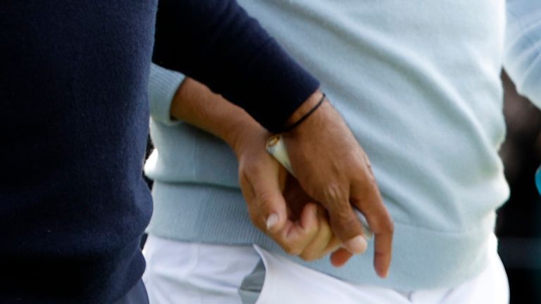 Getty Image of Tiger Woods handing tampon to player