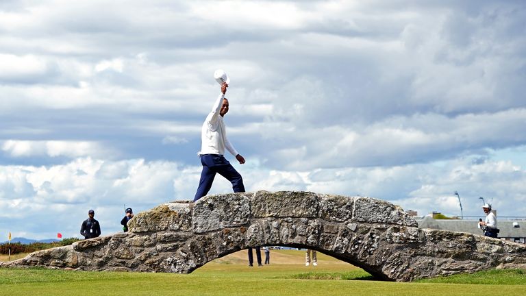File photo dated 15-07-2022 of Tiger Woods waves to the crowd as he crosses Swilcan Bridge during day two of The Open at St Andrews. 