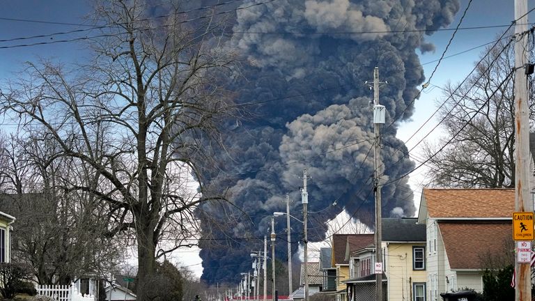A black plume of smoke rises over East Palestine, Ohio, due to the controlled detonation of a partially derailed Norfolk and Southern train. Image: AP