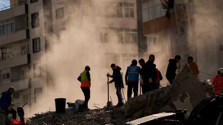 Members of the emergency team search for people in a destroyed building in Adana, Turkey Pic: AP