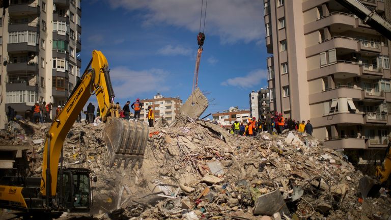 Emergency rescue members search for people in a destroyed building in Adana, Turkey 
Pic:AP