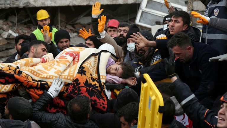 Kurtarma ekipleri, 6 Şubat 2023'te Diyarbakır'da meydana gelen depremin ardından çöken bir binadan bir kız çocuğunu çıkarıyor. REUTERS/Sertaç Kayar Günün TPX GÖRÜNTÜLERİ