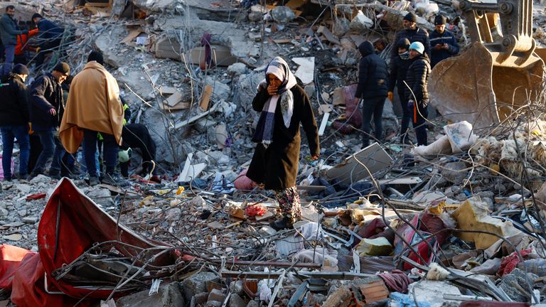 A woman looks at the destruction following an earthquake in Kahramanmaras, Turkey 