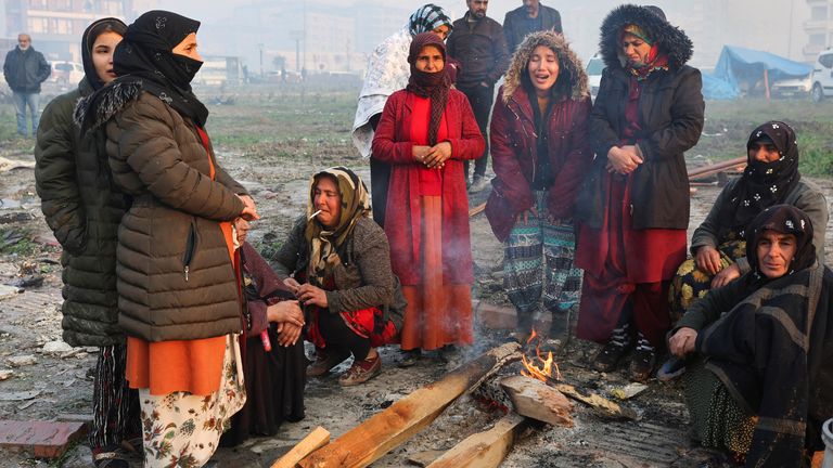 People gather around a fire following an earthquake in Hatay, Turkey 