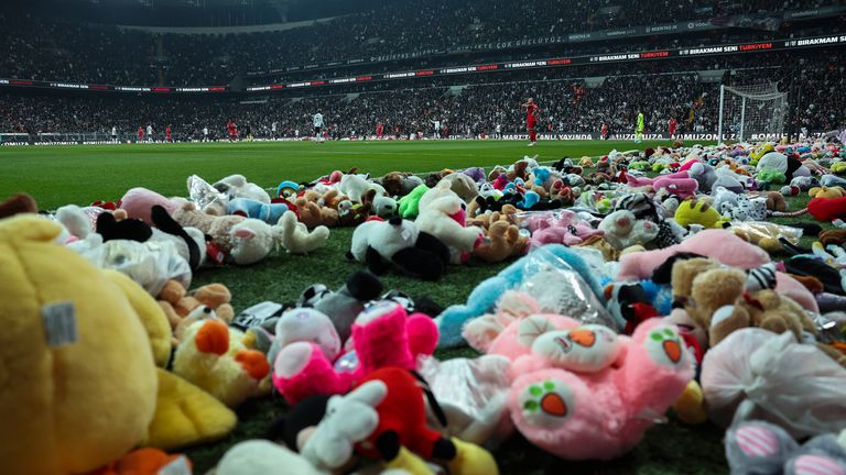 Players resume the game after fans threw toys onto the pitch during the Turkish Super League soccer match between Besiktas and Antalyaspor at the Vodafone stadium in Istanbul, Turkey, Sunday, Feb. 26, 2023. During the match, supporters threw a massive number of soft toys to be donated to children affected by the powerful earthquake on Feb. 6 on southeast Turkey. (AP Photo)