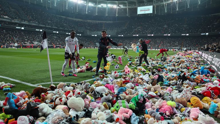 Fans throw toys onto the pitch during the Turkish Super League soccer match between Besiktas and Antalyaspor at the Vodafone stadium in Istanbul, Turkey, Sunday, Feb. 26, 2023. During the match, supporters threw a massive number of soft toys to be donated to children affected by the powerful earthquake on Feb. 6 on southeast Turkey. (AP Photo)