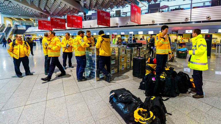 Earthquake aid workers stand in the departure hall of Frankfurt Airport. Pic: AP