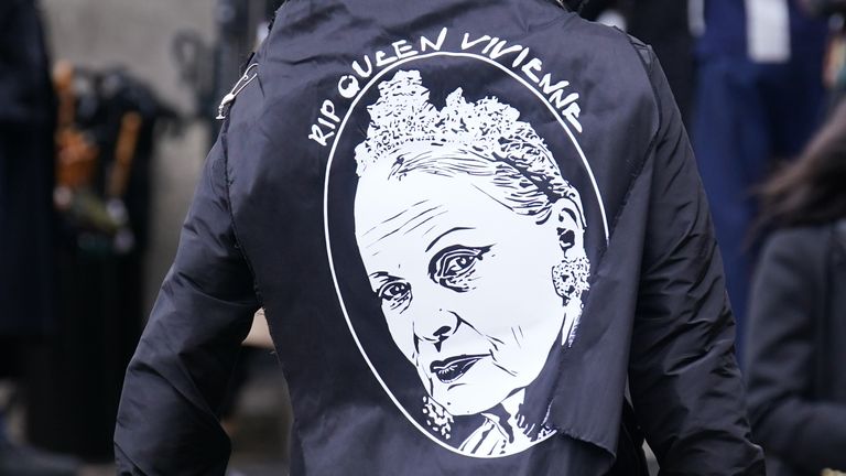 A service-goer wears a fashion tribute to Westwood