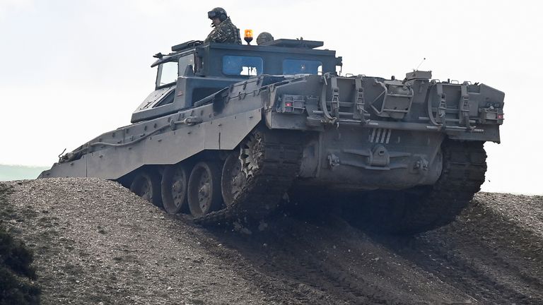 British Defence Secretary Ben Wallace rides on a training tank during tanks and armoured fighting vehicle trials and development tests at Bovington Camp, near Wool in southwestern Britain, February 22, 2023. REUTERS/Toby Melville
