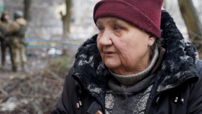 Yemilia, 67-year-old resident of Vuhledar, venturing out for water