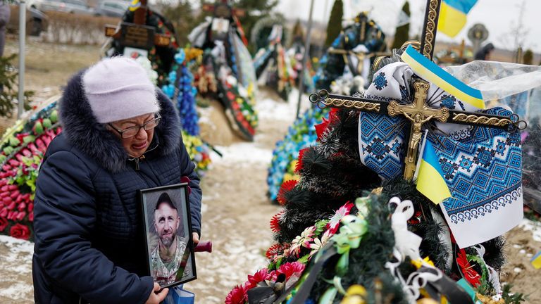 Mariia reacts near the grave of her son Vasyl Kurbet, Ukrainian service member killed in a fight against Russian troops, on a day of the first anniversary of Russia&#39;s attack on Ukraine, at a cemetery in the town of Bucha, outside Kyiv, Ukraine February 24, 2023.  REUTERS/Valentyn Ogirenko.