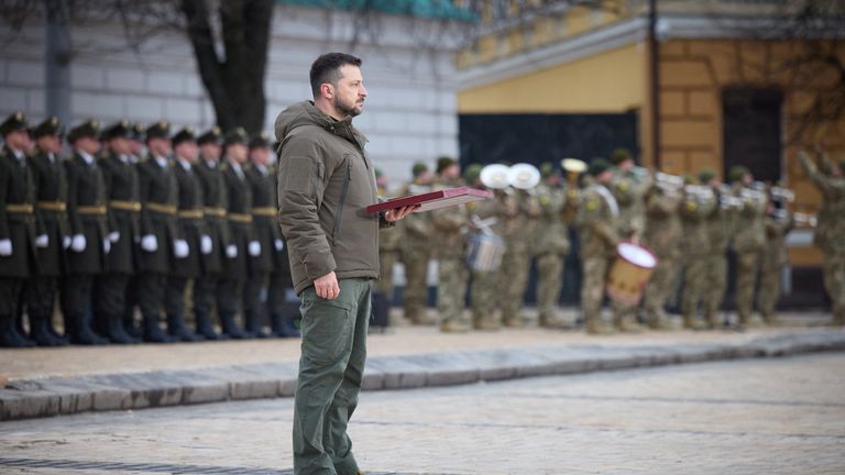 Ukraine&#39;s President Volodymyr Zelenskyy handovers a flag to a serviceman during a ceremony dedicated to the first anniversary of the Russian invasion of Ukraine, amid Russia&#39;s attack on Ukraine, in Kyiv, Ukraine February 24, 2023. Ukrainian Presidential Press Service/Handout via REUTERS ATTENTION EDITORS - THIS IMAGE HAS BEEN SUPPLIED BY A THIRD PARTY.
