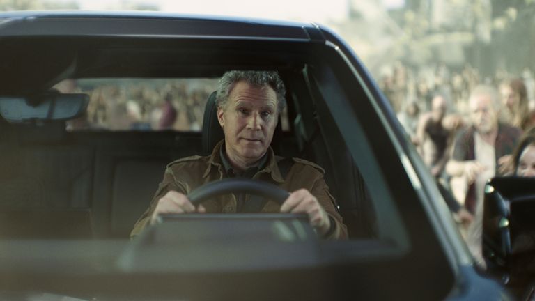 This photo provided by Netflix/GM, Will Ferrell drives a GMC Sierra EV Denali as he is chased by zombies from Netflix&#39;s Army of the Dead from a scene from Netflix/GM 2023 Super Bowl NFL football spot. ( Netflix/GM via AP)