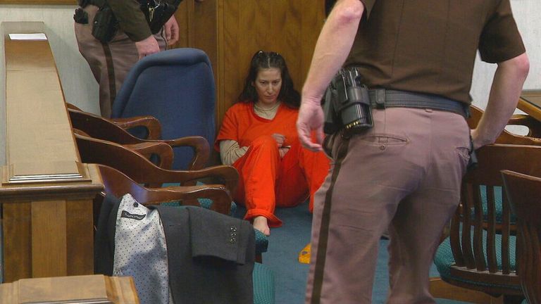 Taylor Schabusiness sits on the floor of a Brown County courtroom after attacking her attorney, Quinn Jolly, during a court hearing in Green Bay, Wis., on Tuesday, Feb. 14, 2023. Schabusiness is charged with first-degree intentional homicide, mutilating a corpse and third-degree sexual assault in the killing of Shad Thyrion, 25, in February 2022. (WLUK/Tim Flanigan via AP)


