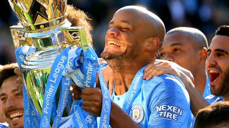 Manchester City&#39;s Vincent Kompany celebrates with the trophy during the Premier League match at the AMEX Stadium, Brighton. 