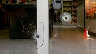 Bullets holes crack the windows of the Unico supermarket, a grocery chain owned by soccer player Lionel Messi&#39;s in-laws, in Rosario, Argentina, Thursday, March 2, 2023. (AP Photo/Sebastian Lopez Brach)