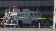 An armored truck is surrounded by police tape at the Arturo Merino Benitez International Airport in Santiago, Chile