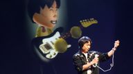 Legendary Nintendo game designer Shigeru Miyamoto demonstrates the new game &#39;Wii Music&#39; by virtually playing a guitar at the Nintendo E3 media briefing in Hollywood, California July 15, 2008. REUTERS/Fred Prouser (UNITED STATES)