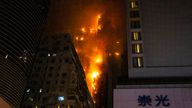 A fire burns at a construction site in Hong Kong, Friday, March 3, 2023. Hong Kong firefighters are battling the blaze that broke out at a construction site in the city&#39;s popular shopping district. (AP Photo/Louise Delmotte)