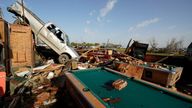 A pickup truck rests on top of a restaurant cooler at Chuck&#39;s Dairy Cafe in Rolling Fork, Miss., Saturday, March 25, 2023. .   Emergency officials in Mississippi say several people have been killed by tornadoes that tore through the state on Friday night, destroying buildings and knocking out power as severe weather produced hail the size of golf balls moved through several southern states.  (AP Photo/Rogelio V. Solis)