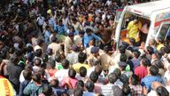 An accident victim is carried towards a waiting ambulance in Indore, India, Thursday, March 30, 2023. A structure built over an old temple well in India collapsed Thursday as a large crowd of devotees prayed at a festival for Rama, one of the most widely worshipped Hindu deities, killing at least eight people, police said. (AP Photo)