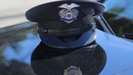 A Los Angeles Police Department (LAPD) officer&#39;s cap rests on the hood of a patrol vehicle in Los Angeles, California, U.S. March 4, 2018. Picture taken March 4, 2018. REUTERS/Chris Helgren