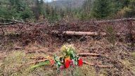 Flowers and candles are placed in a woodland near the place where a 12-year-old girl was found dead