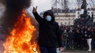 A masked protester reacts near a fire during clashes at a demonstration as part of the tenth day of nationwide strikes and protests against French government&#39;s pension reform, in Paris, France, March 28, 2023. REUTERS/Gonzalo Fuentes