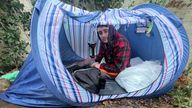 Connolly Burden in his pop-up tent in the woods outside North Walsham in Norfolk