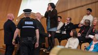 Police officers remove a protestor during the First Minister&#39;s Questions at the Scottish Parliament at Holyrood, in Edinburgh, Scotland, Britain, March 30, 2023. REUTERS/Russell Cheyne