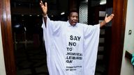 Member of Parliament from Bubulo contituency John Musira dressed in an anti gay gown gestures as he leaves the chambers during the debate of the Anti-Homosexuality bill,