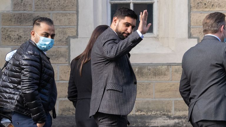 Former world boxing champion Amir Khan waves as he arrives at Snaresbrook Crown Court on Tuesday
