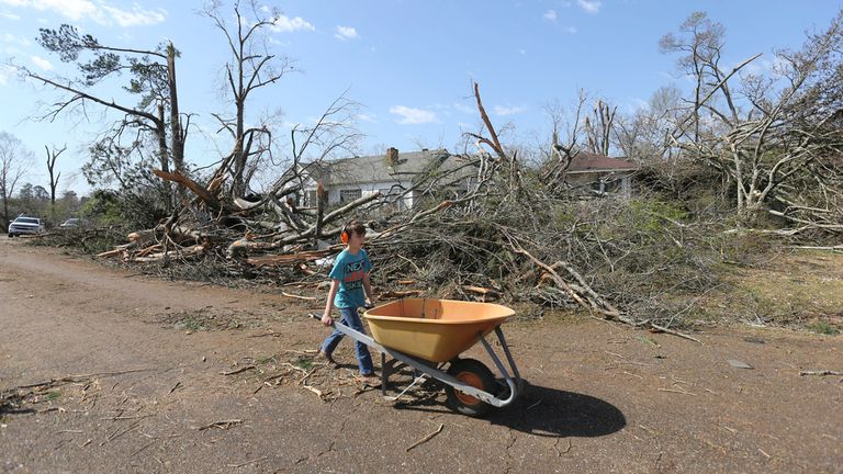 Wyatt Stanford, 10, of Amory, Mississippi, was heading to the house next door to help remove fallen trees and other debris.Photo: Associated Press