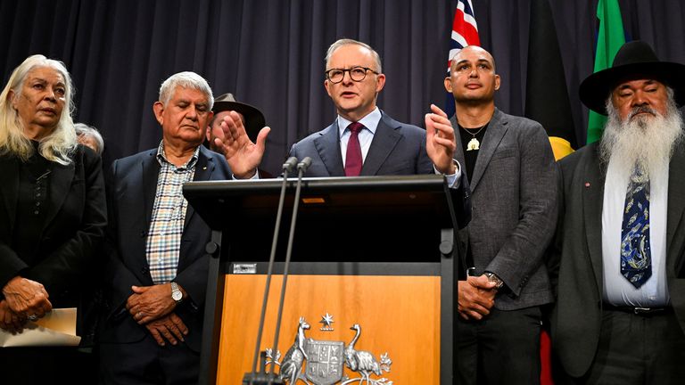 Australian Prime Minister Anthony Albanese, surrounded by members of the First Nations Referendum Working Group, speaks to the media during a news conference at Parliament House in Canberra